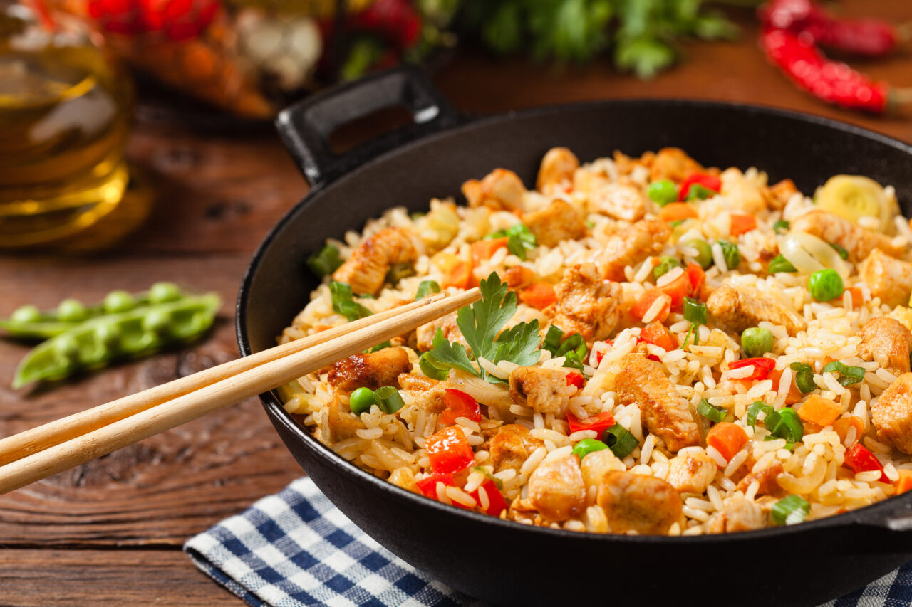 fried,rice,with,chicken.,prepared,and,served,in,a,wok.