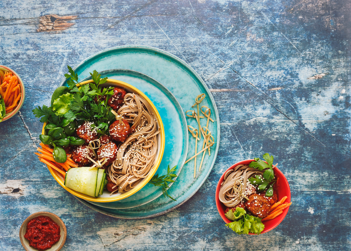 thai,chicken,meatball,noodle,bowls,with,green,vegetables,and,herbs.